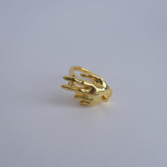 Unique gold ring with hand facing down