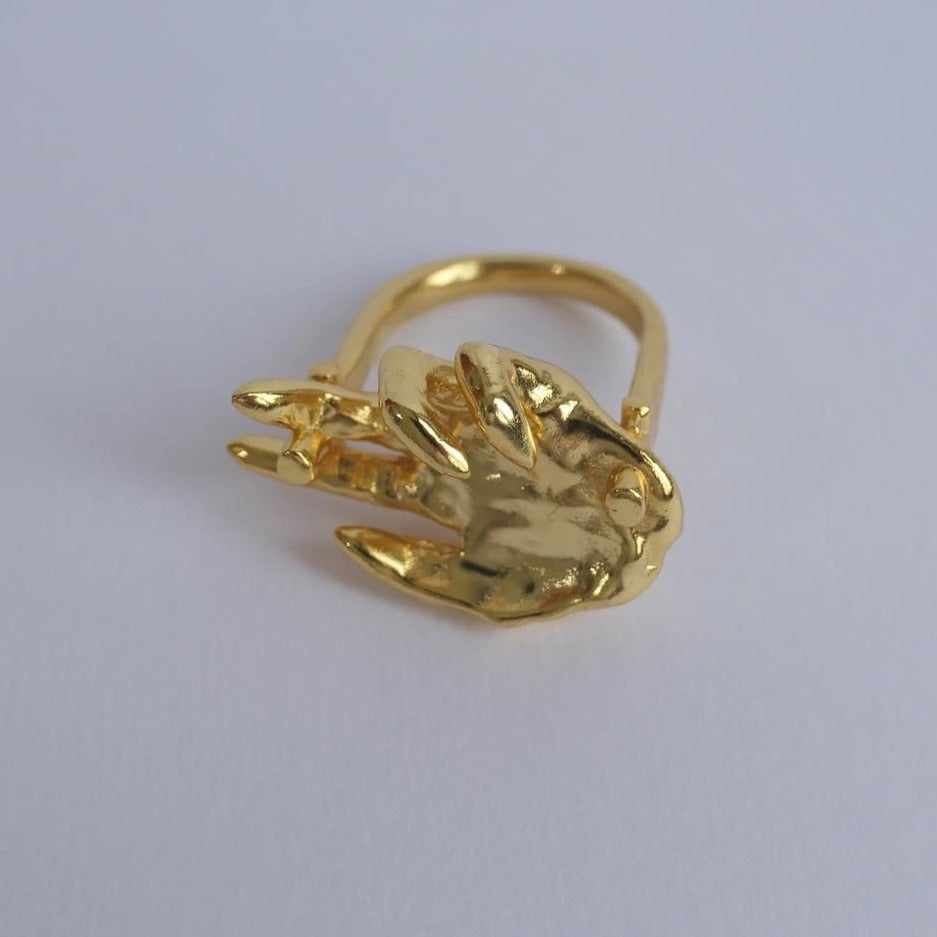 Unique gold ring with hand facing up