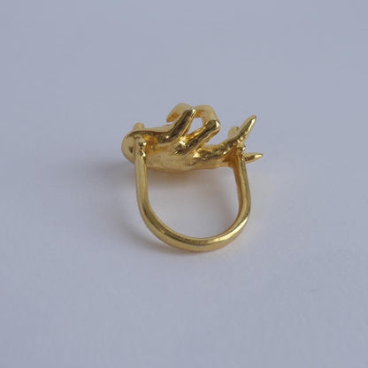 Unique gold ring with hand facing up